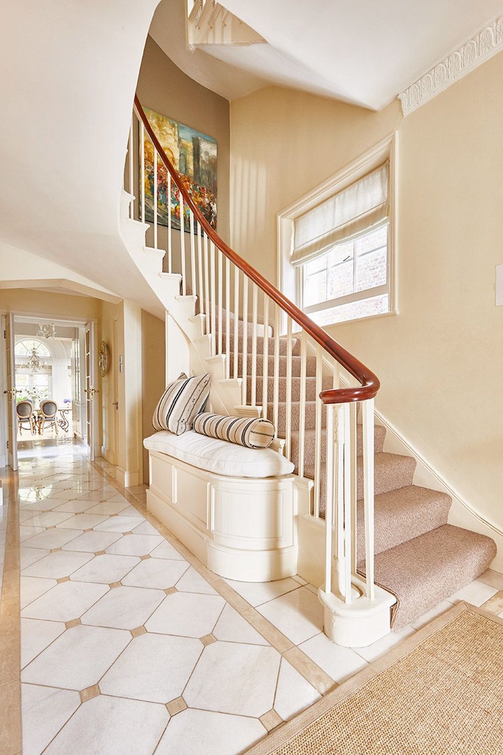 Carpeted staircase leads to the bedrooms upstairs