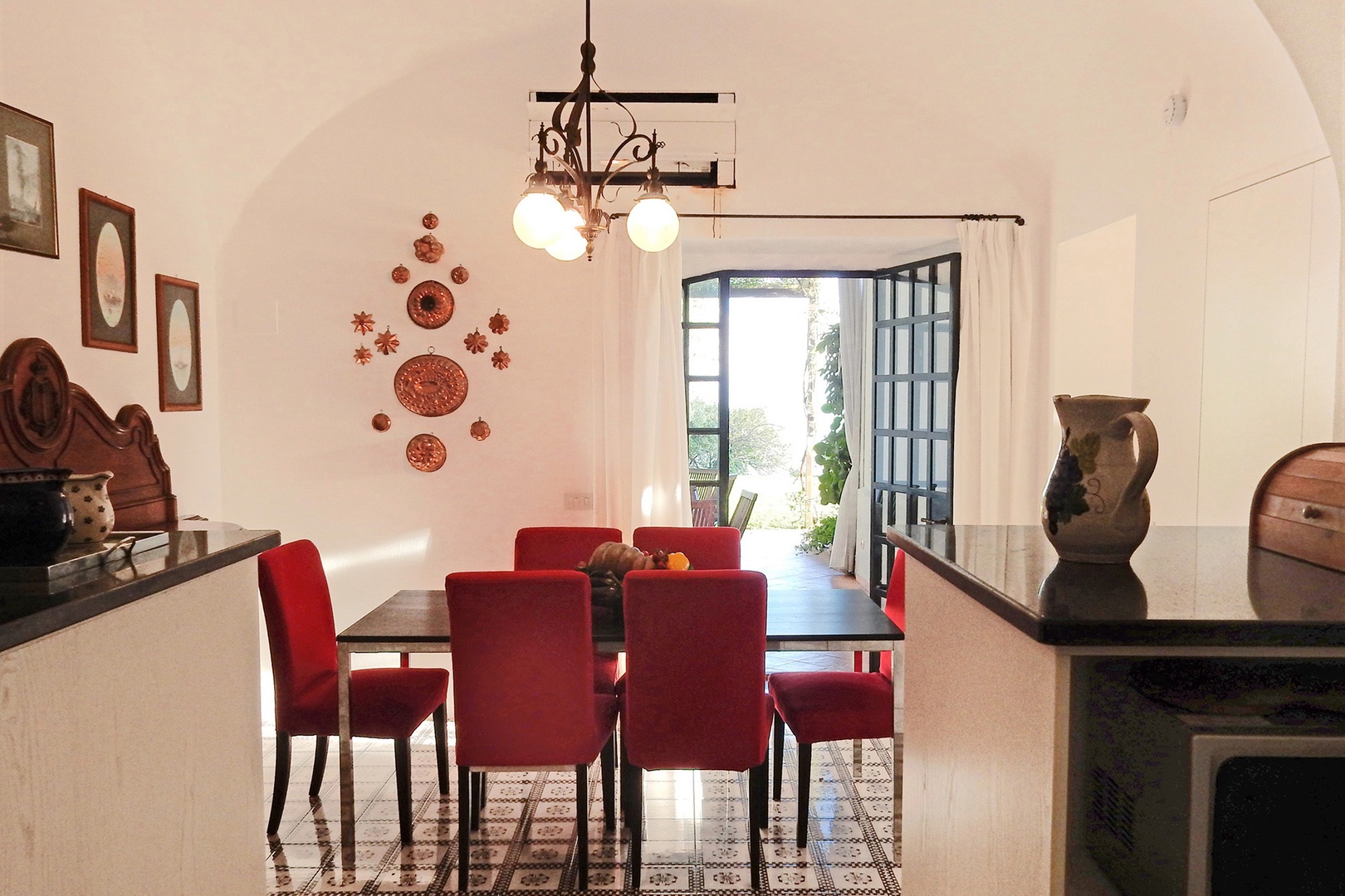 Eat-in kitchen. French doors open out to shaded terrace off kitchen.