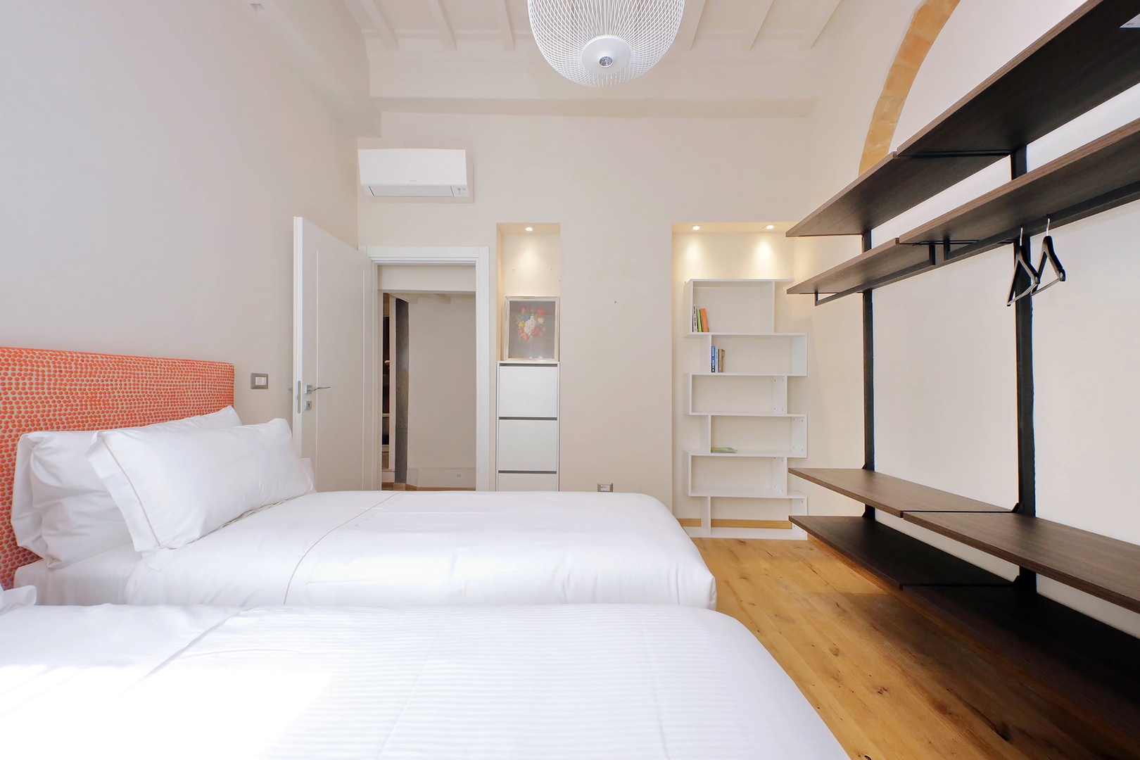Wall-mounted open closet adds to the modern feel.