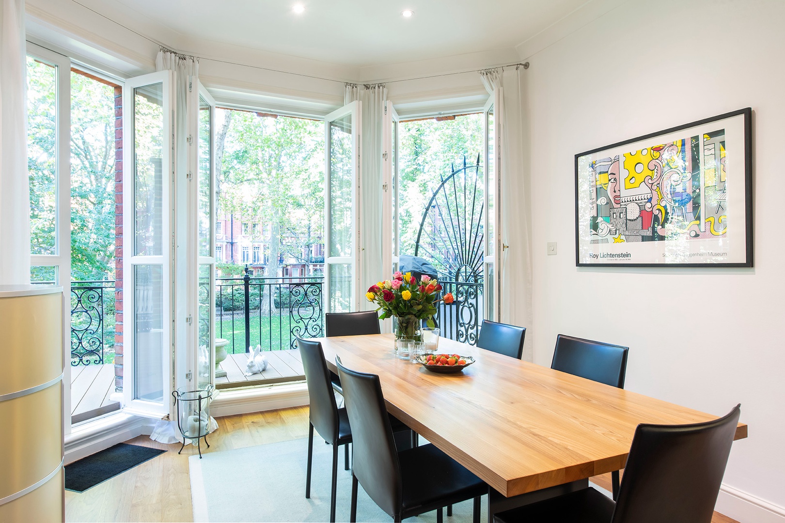 Beautiful dining area with views over private garden square and access to terrace.