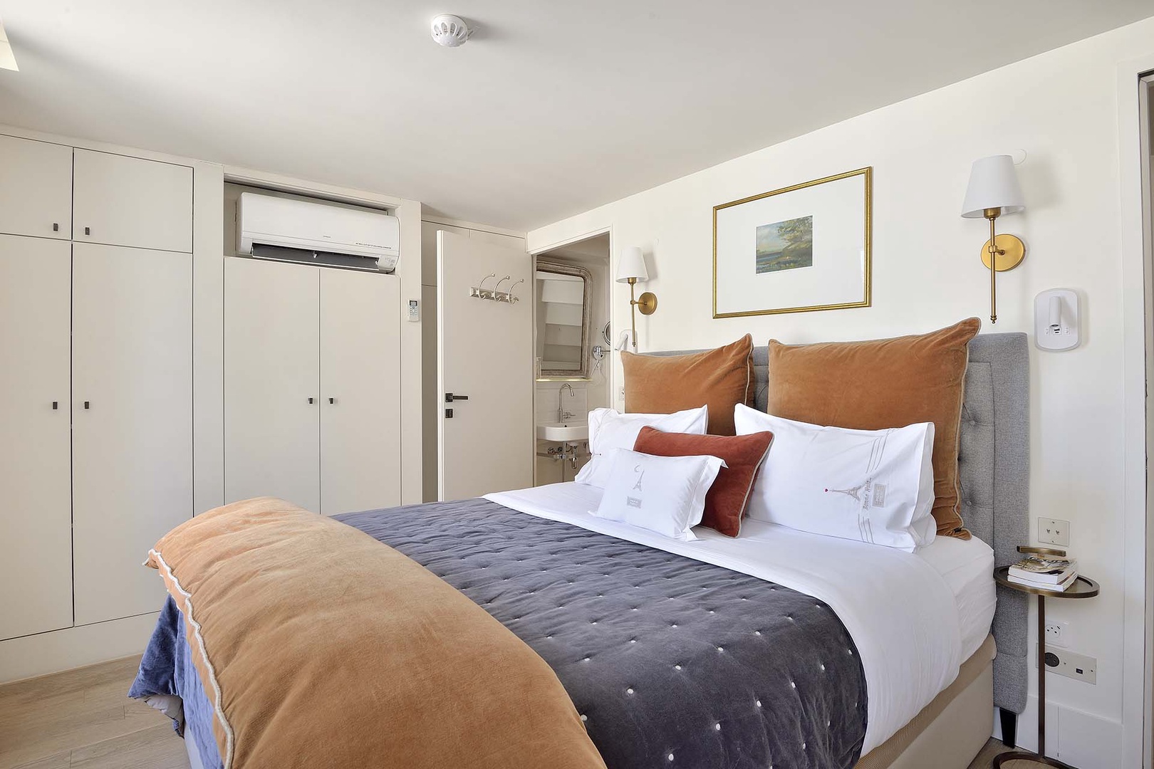 Relax in the stylish bedroom with a comfortable bed and en suite bathroom.