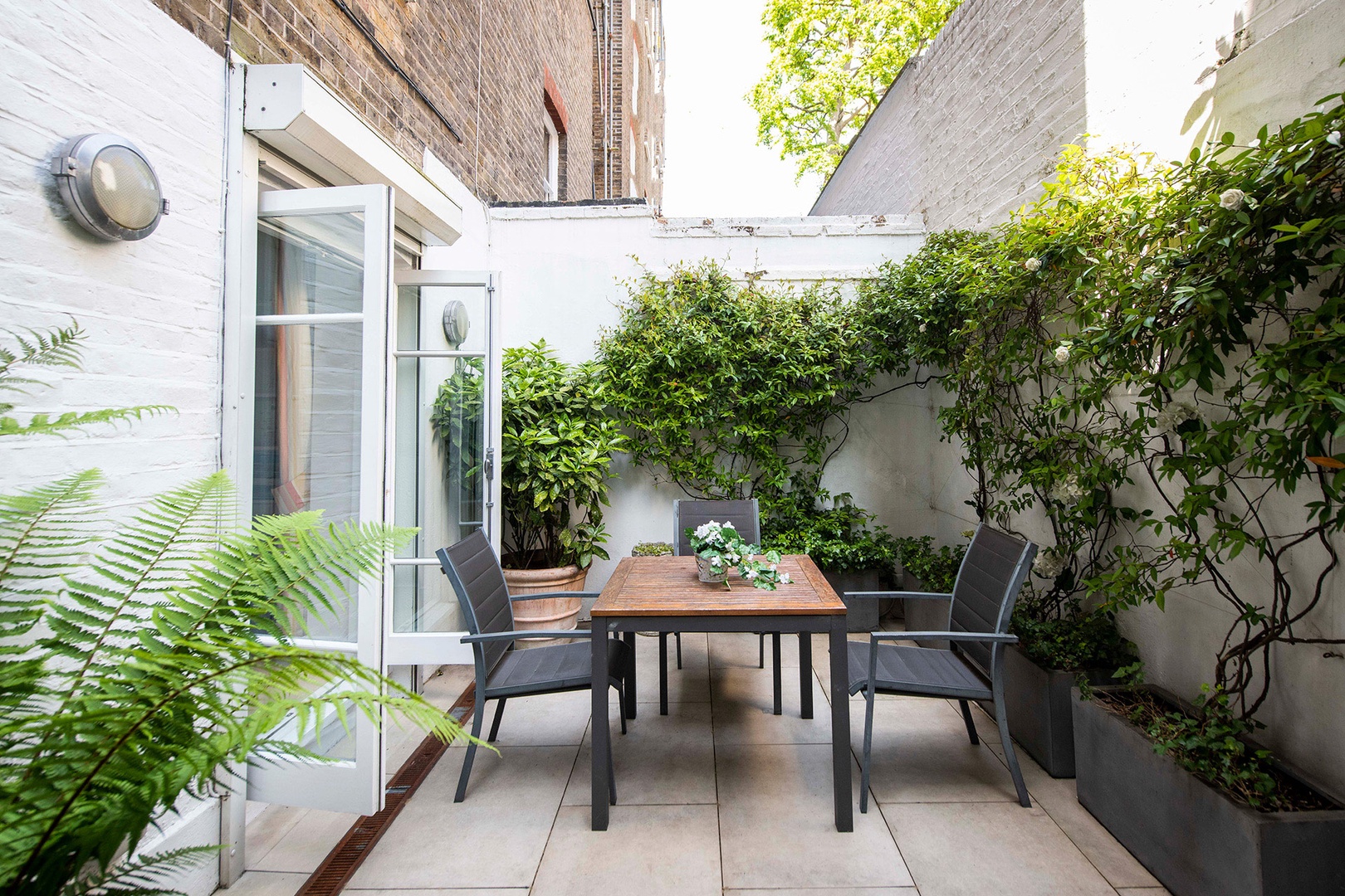 Step out onto the private patio garden just off the den