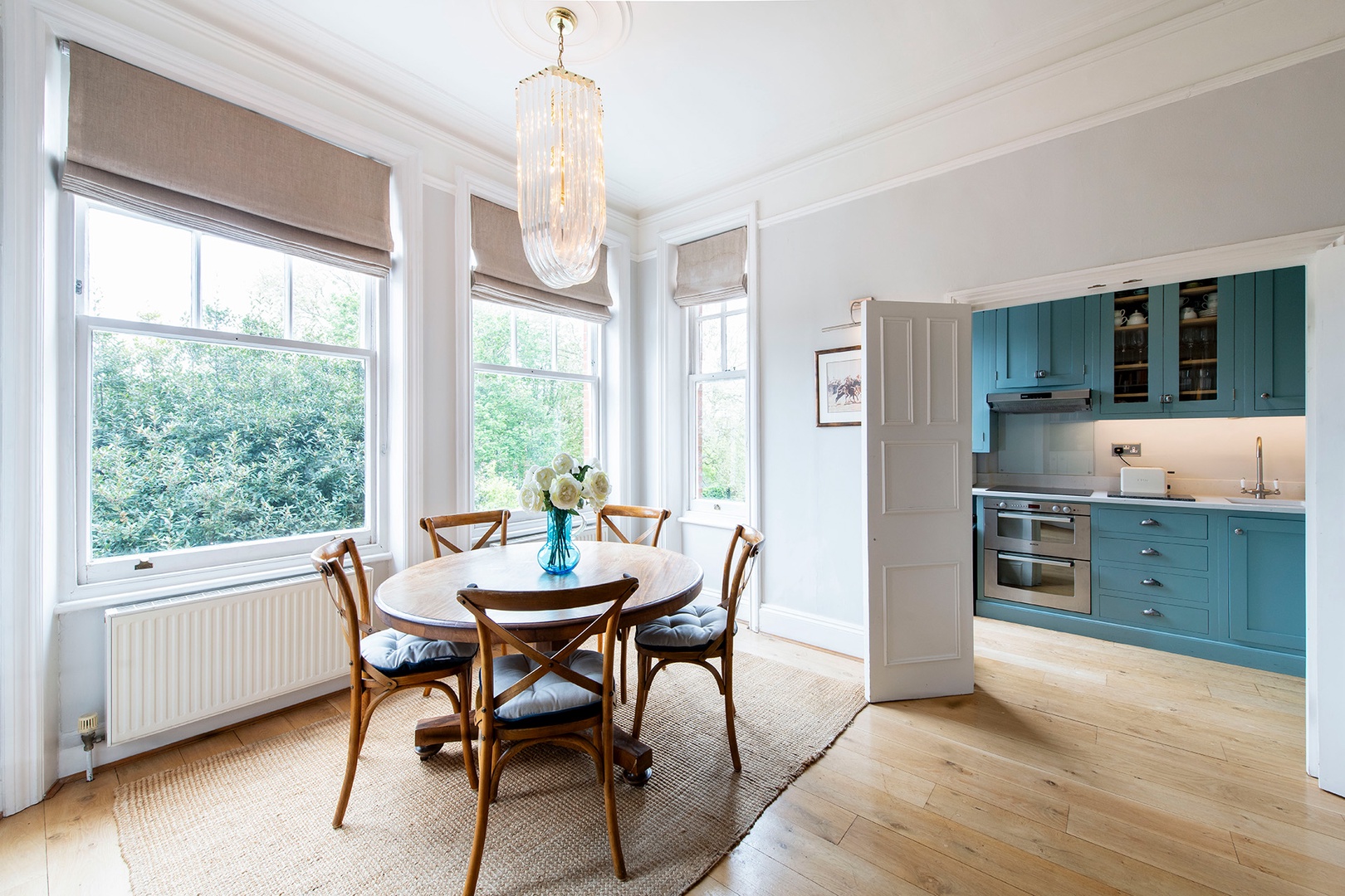 Wooden dining table just off the kitchen can seat 5.