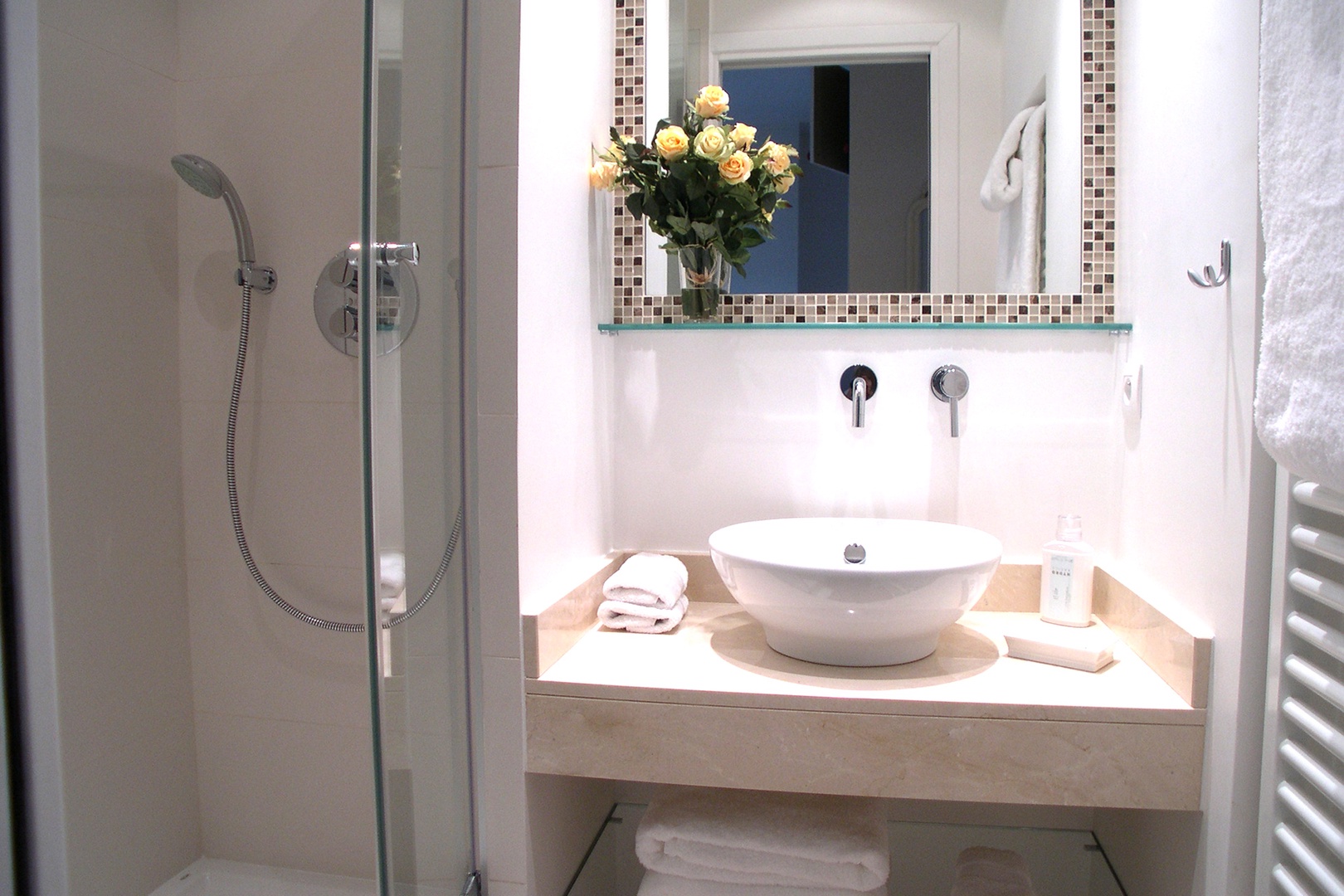 The en suite bathroom features a large shower and porcelain sink.