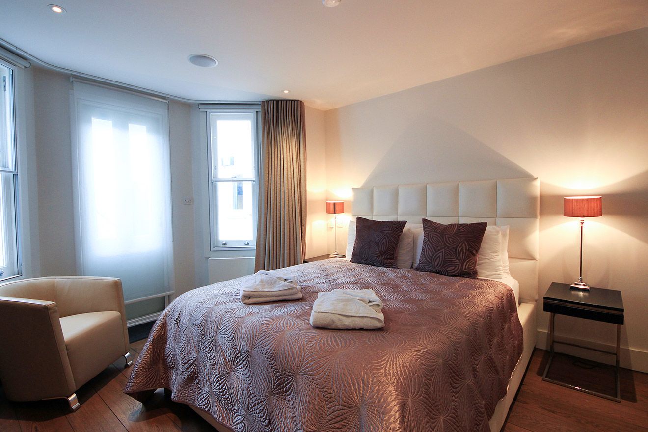 Bedroom 1 with a comfortable bed, TV and en suite bathroom