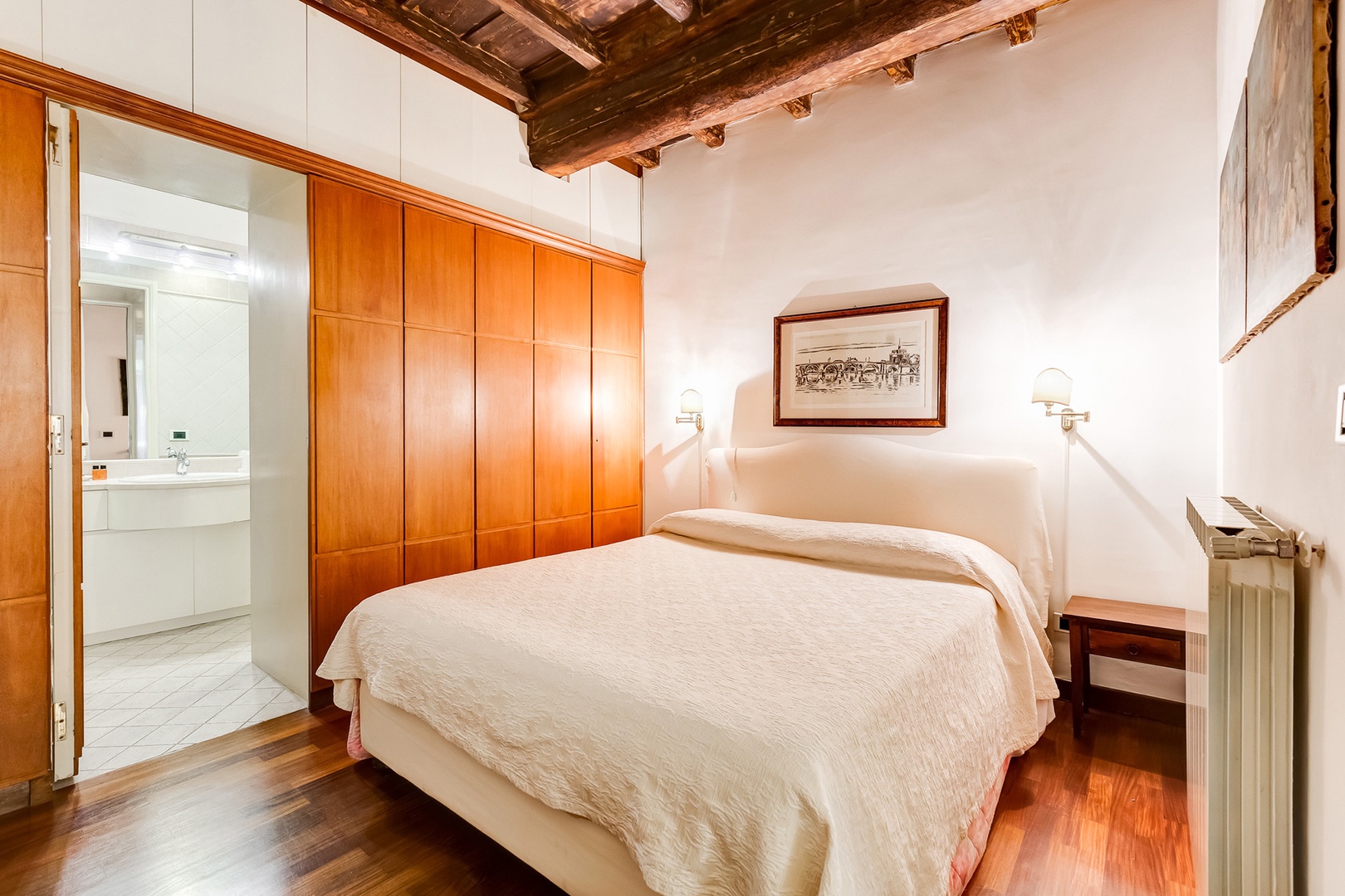 Clever wall of closets in Bedroom conceals door to the bathroom.