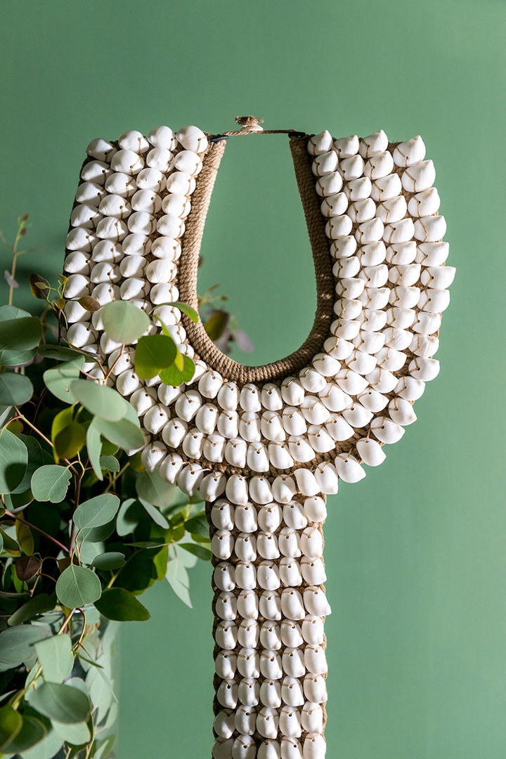 The apartment boasts interesting artwork, such as this Papua New Guinea collar made from shells.