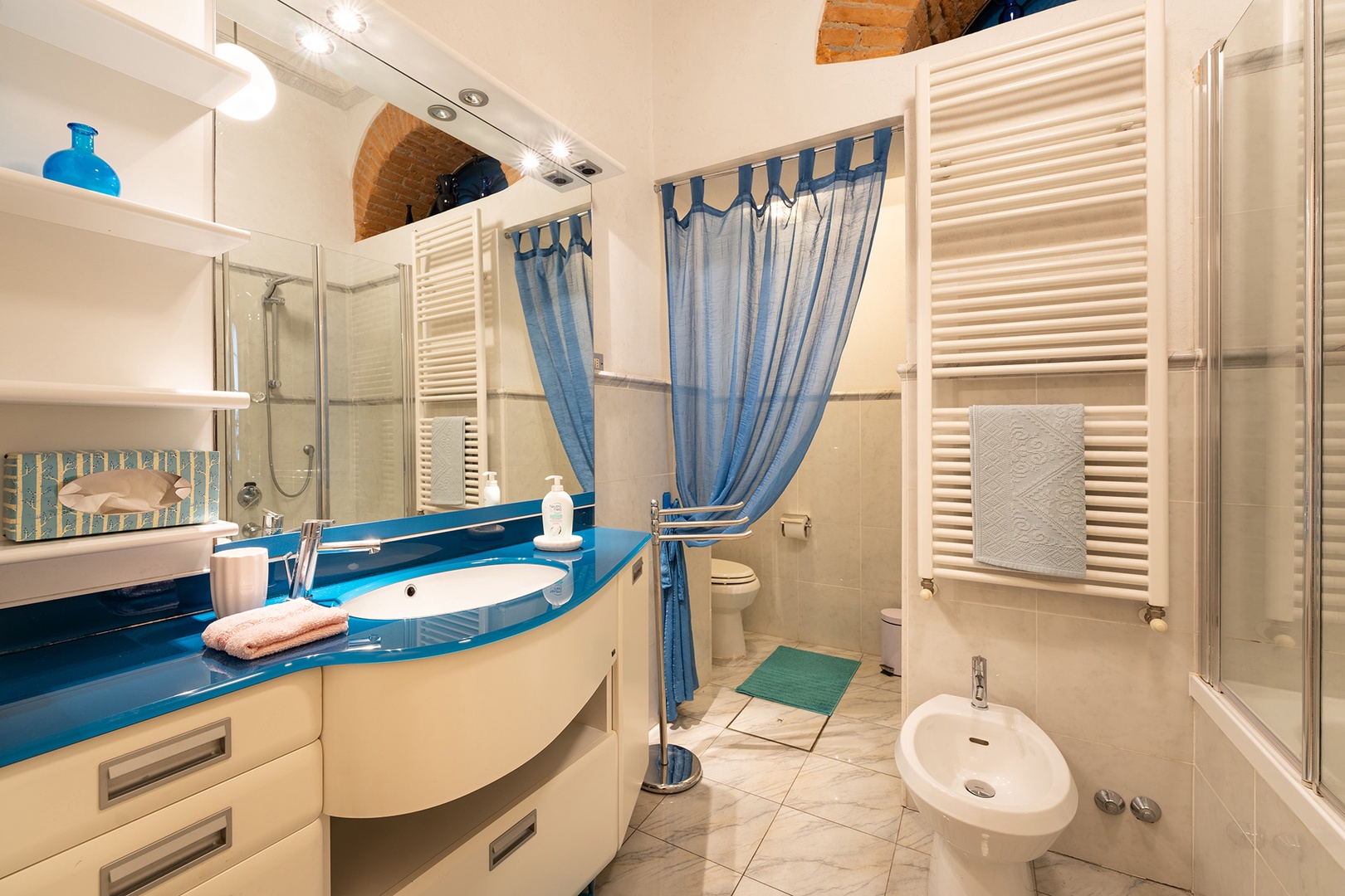 Bathroom has shower, sink and toilet