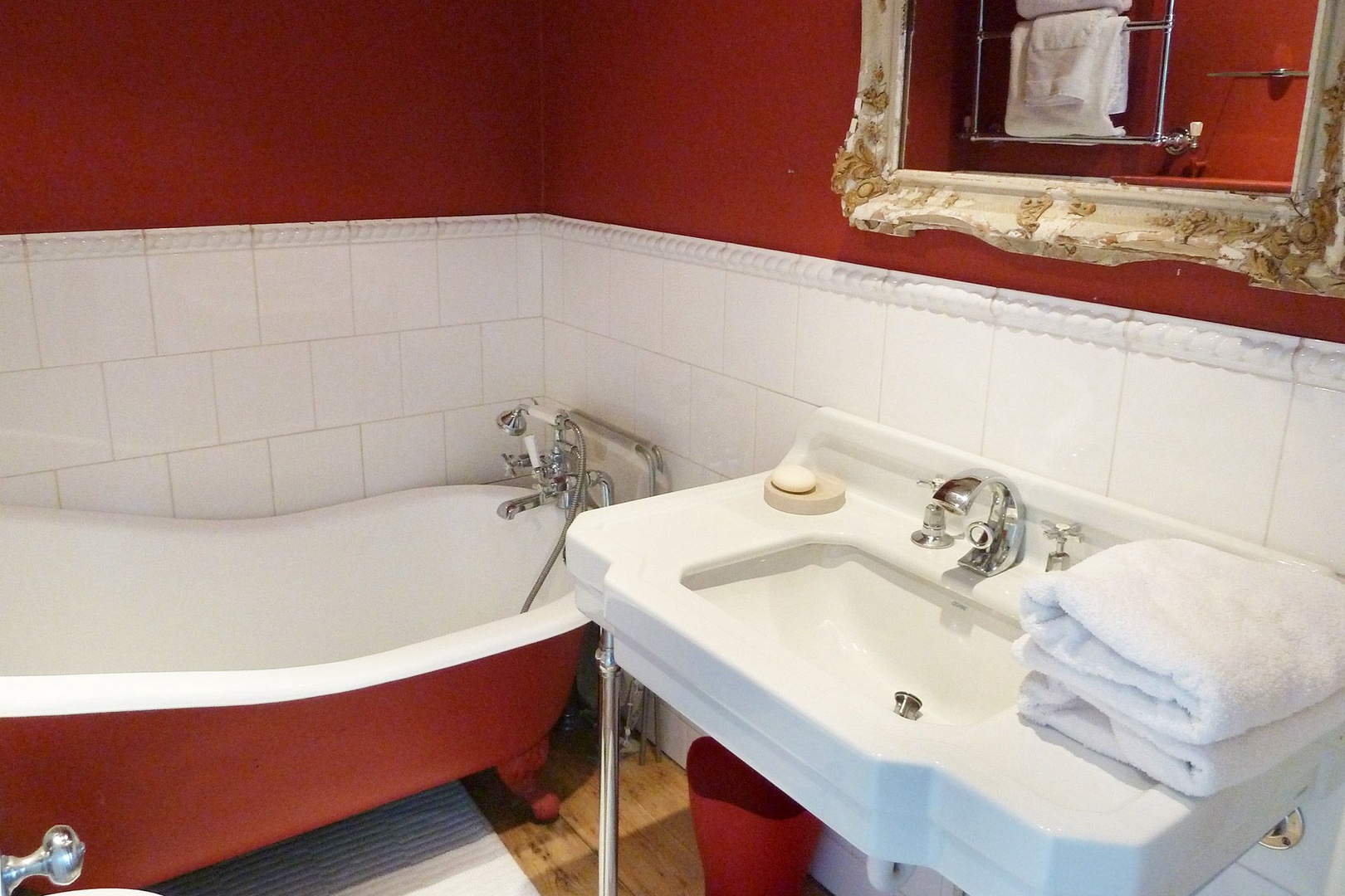 En suite bathroom to second bedroom with clawfoot cast iron bathtub