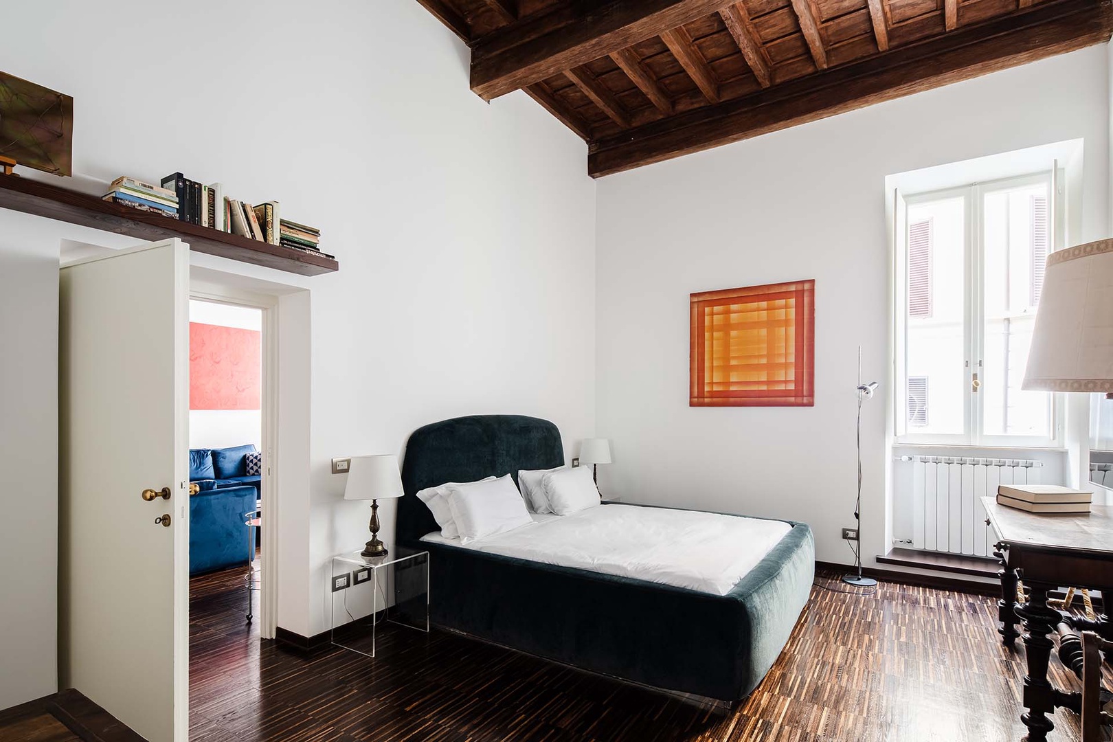 Bedroom 1 has the same high wooden beamed ceiling as the living area.