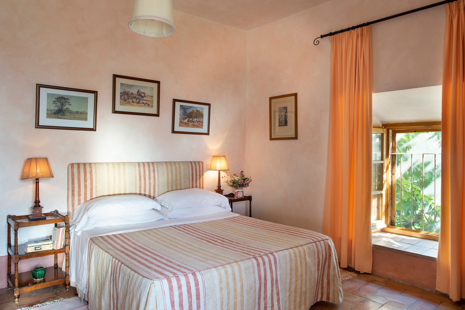 The bedroom has windows overlooking the open lawn on one side and Monte Amiata on the other.