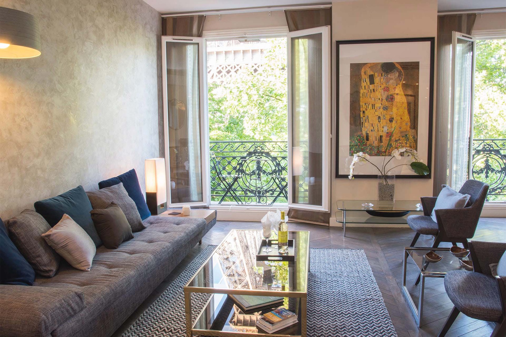 French doors open to a balcony with bistro table.