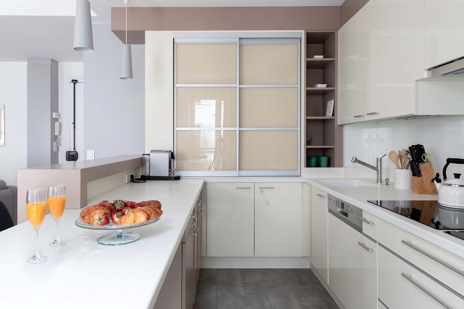 Kitchen features an induction cooktop stove and modern appliances.