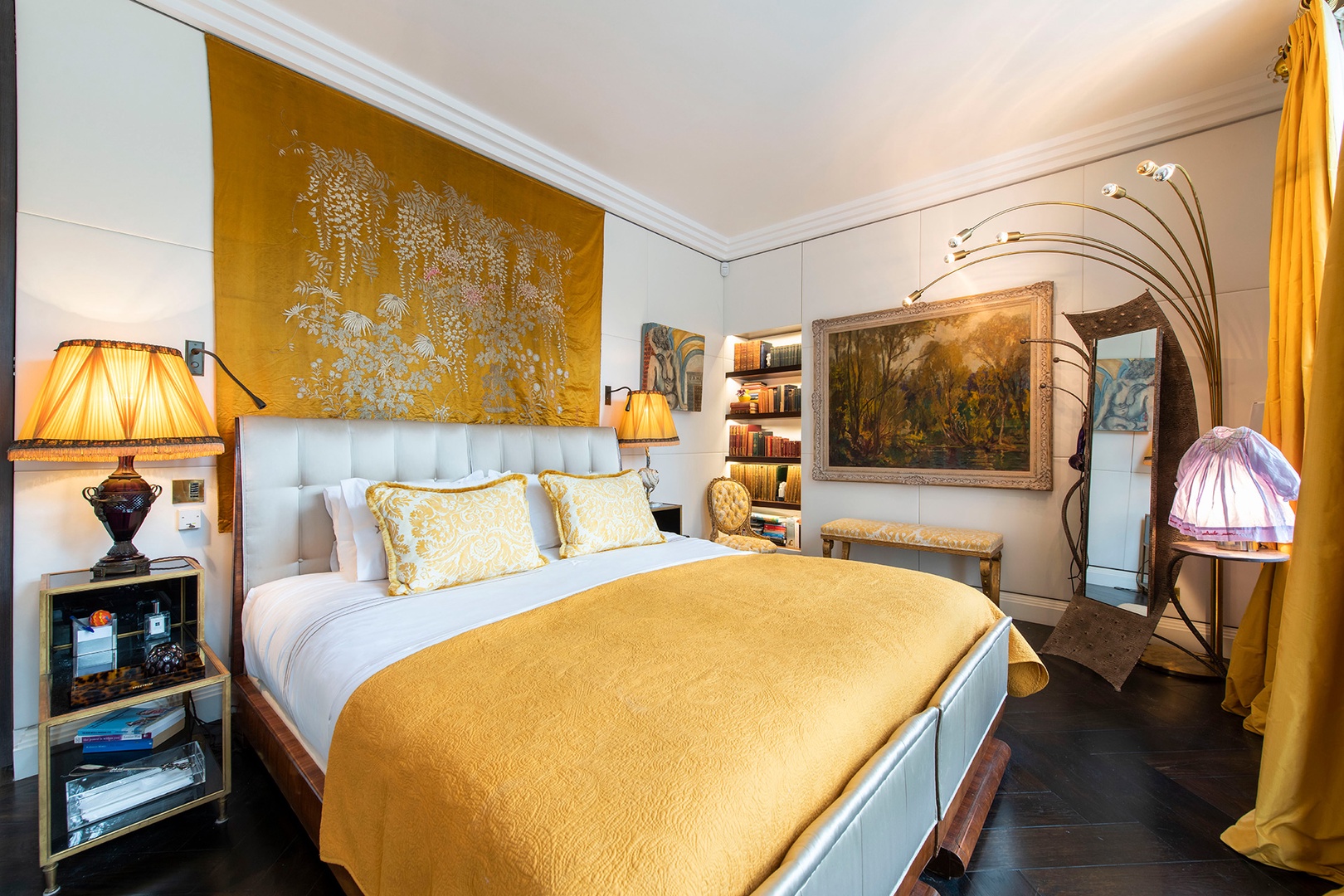 Inviting bedroom with fine art and cheerful warm yellow accents.