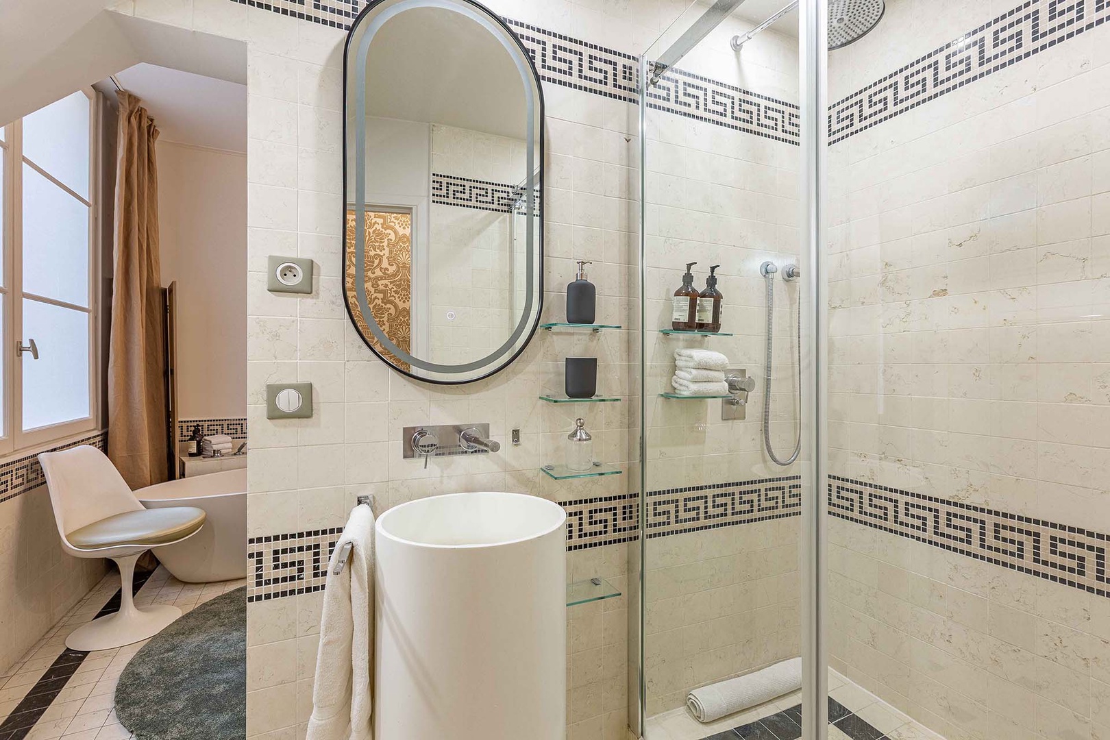 Bathroom features shower and sink.