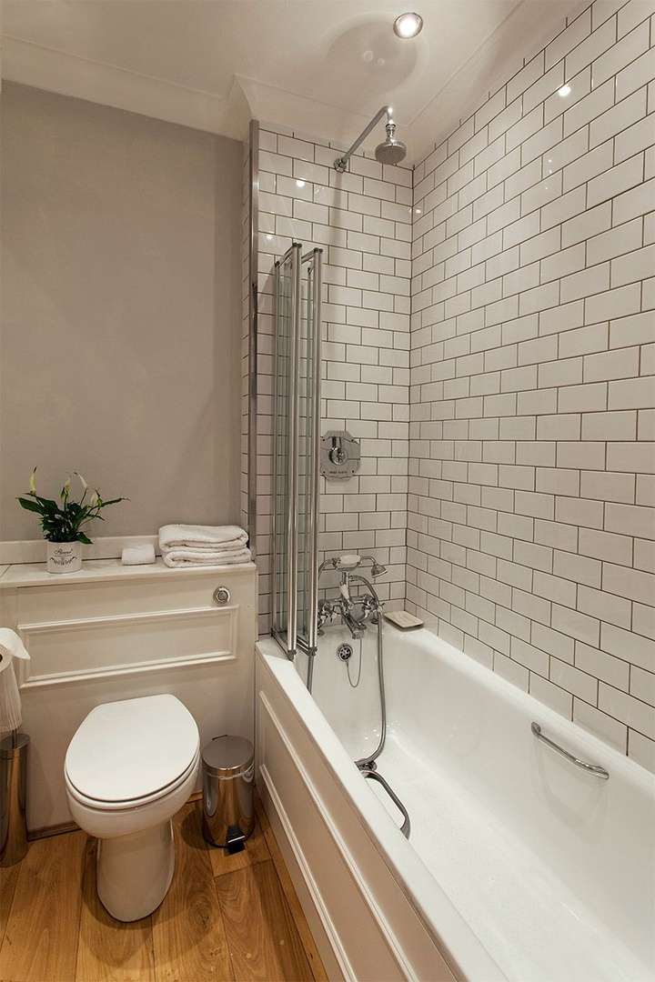 Bathtub with fixed and flexible shower heads.