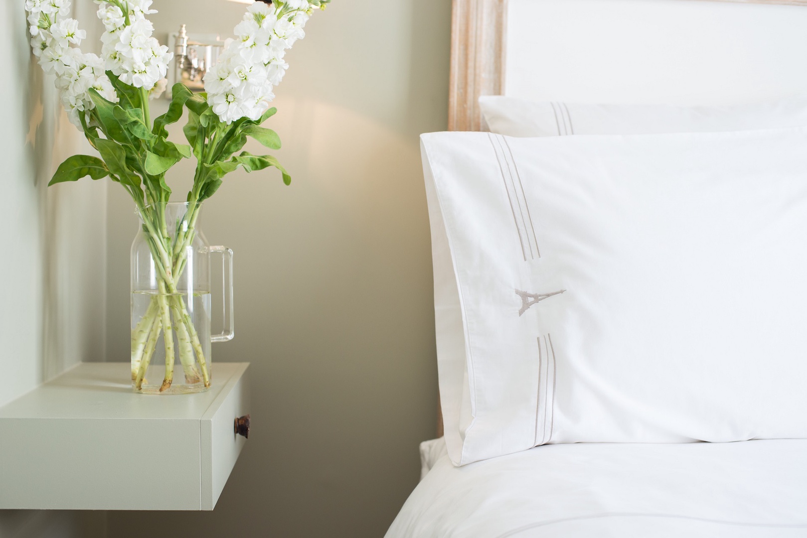 Soft lighting and luxury linens give the bedroom a romantic feel.