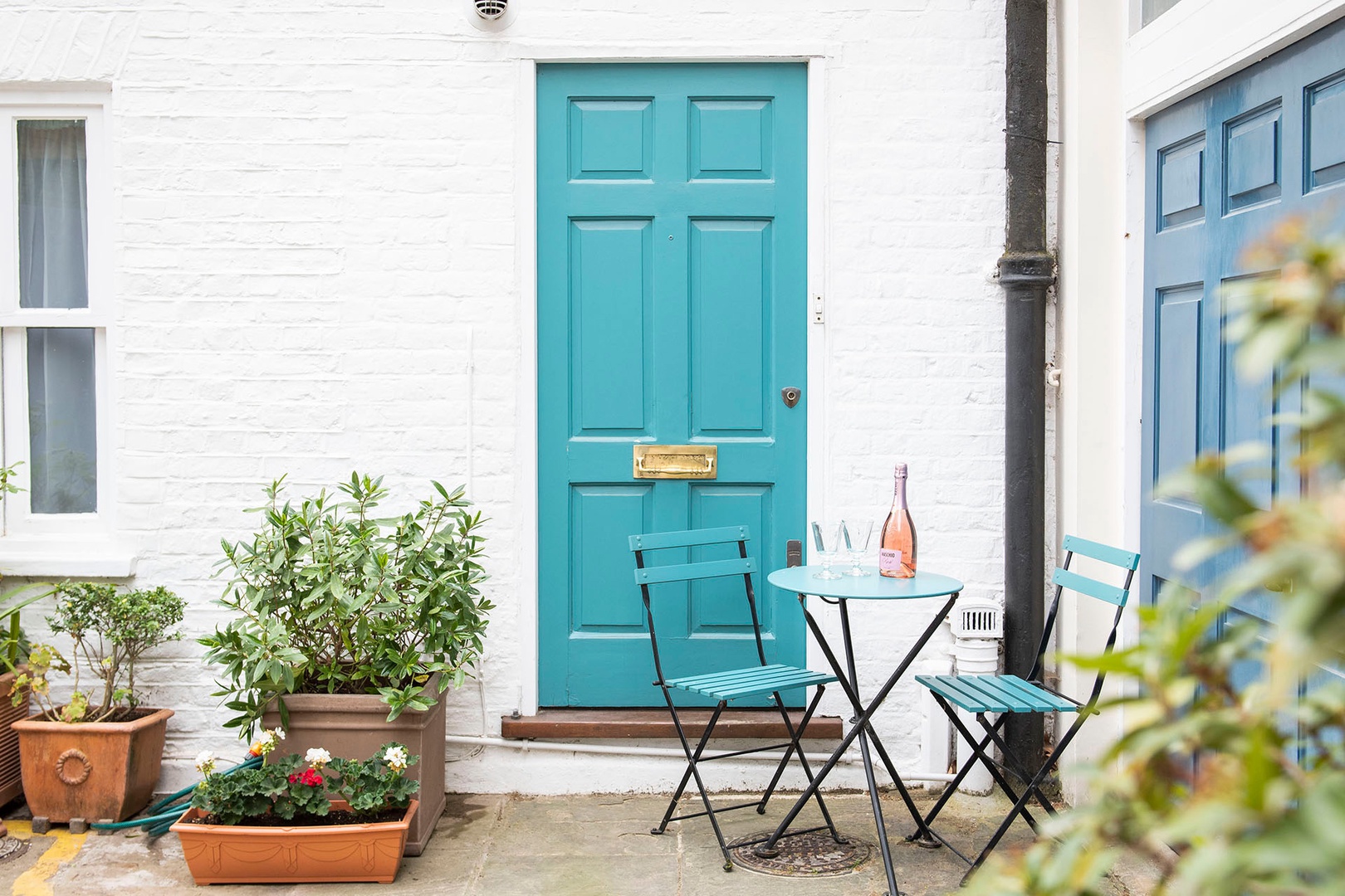 Charming mews entrance with bistro table.
