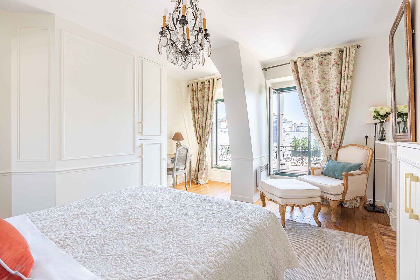 Large French windows in bedroom provide plenty of sunlight.