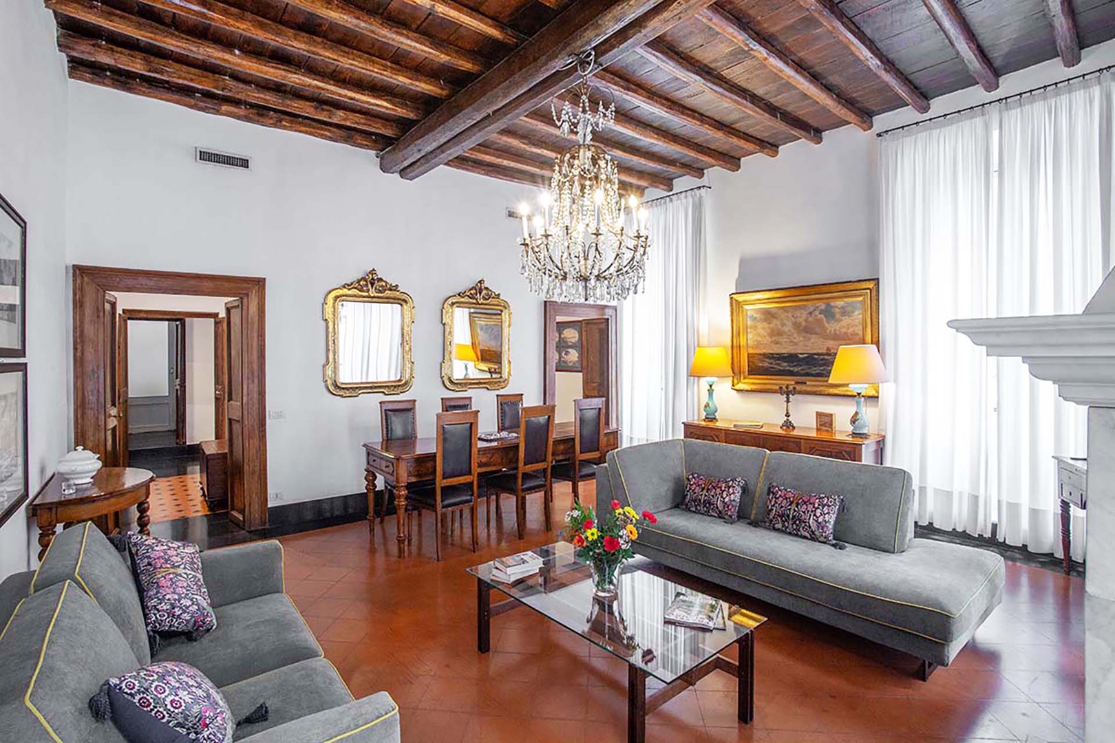 Large living room with a fireplace warms a chilly evening.