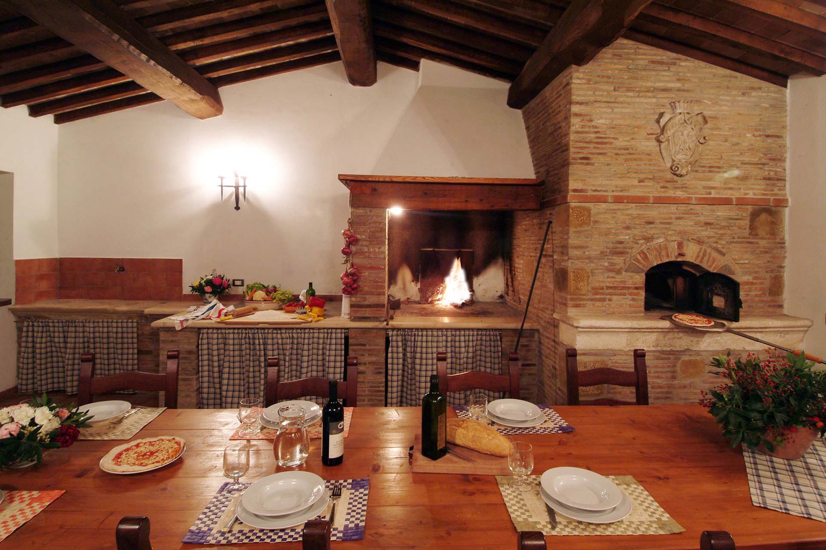 Covered dining space with fireplace, pizza oven and BBQ  for enjoying Tuscan sunsets