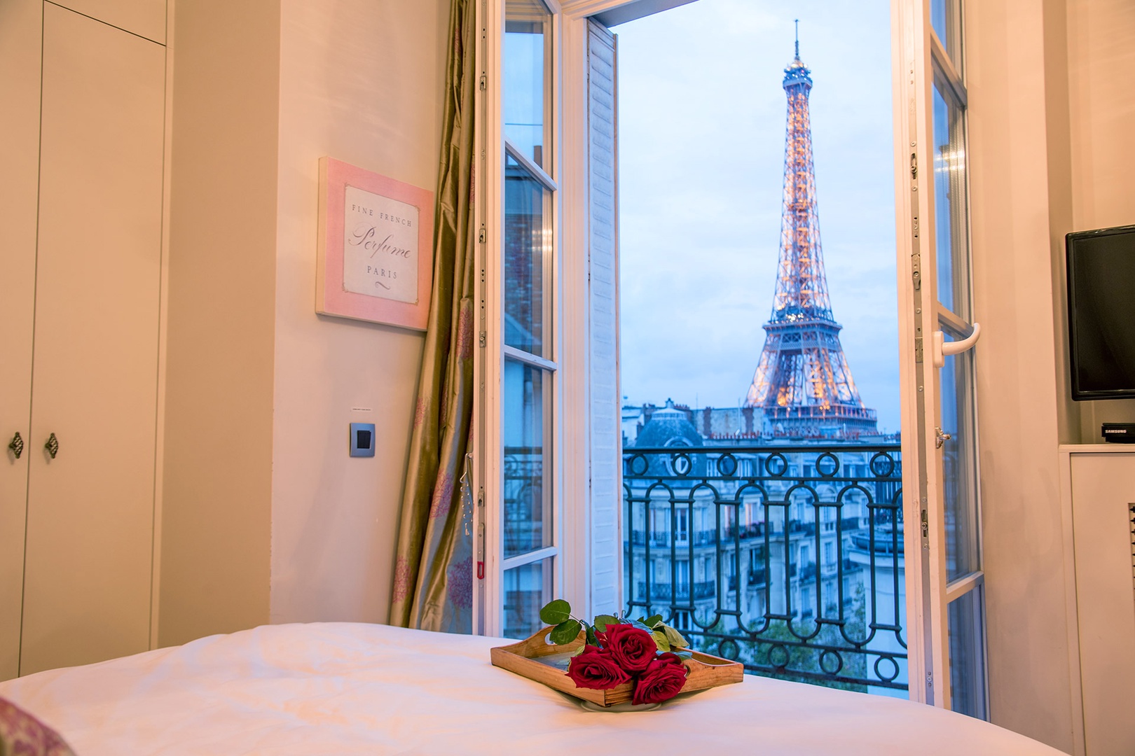 Watch the sunset and the Eiffel Tower light up at night right from your bed!