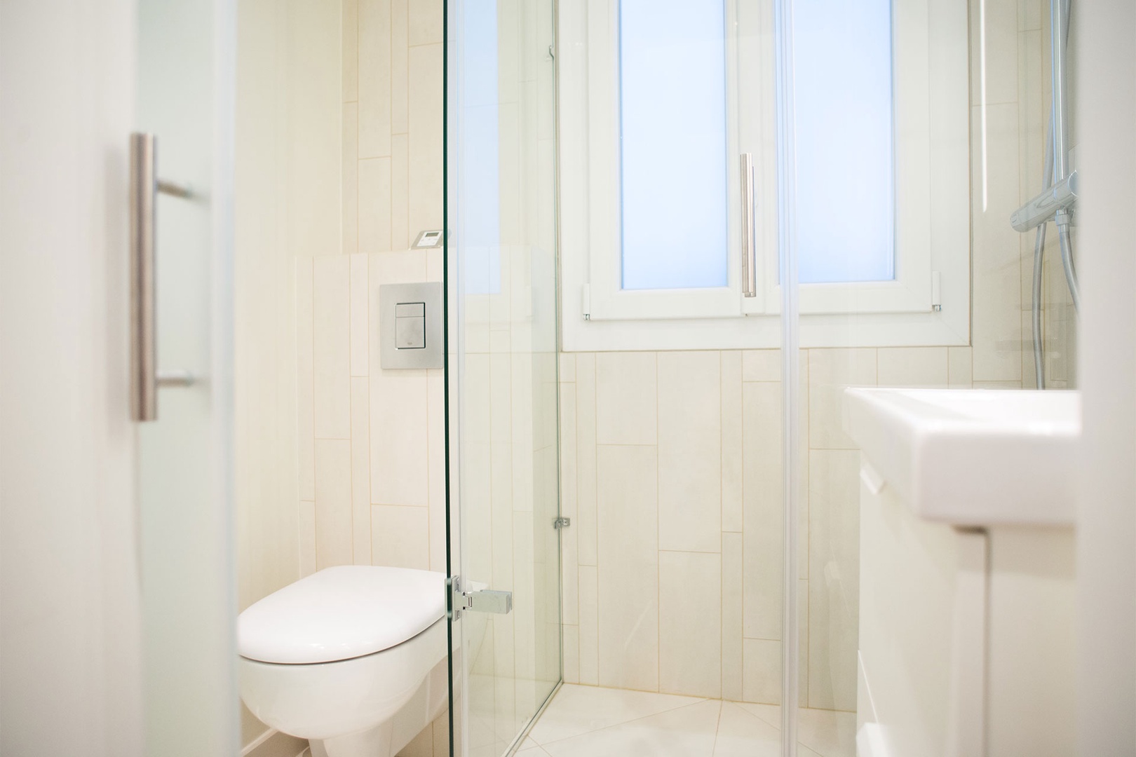 Bathroom 2 located near the entrance with a shower, sink and toilet