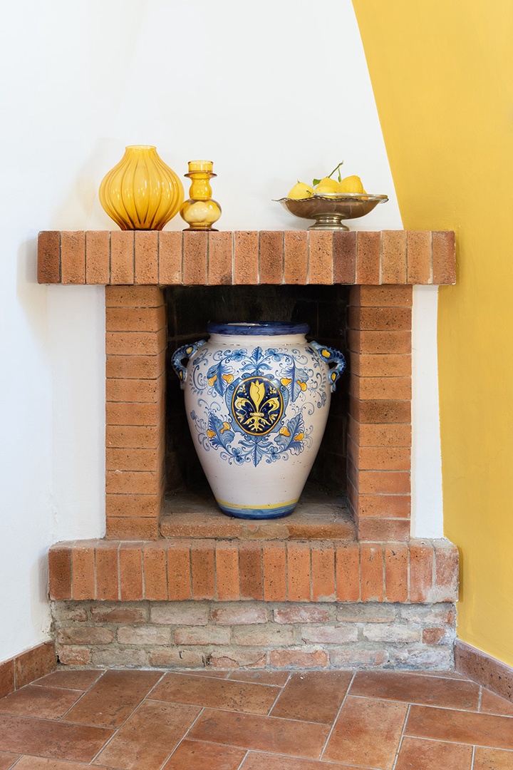 Hand-painted urn enhances the living room's non-working fireplace.