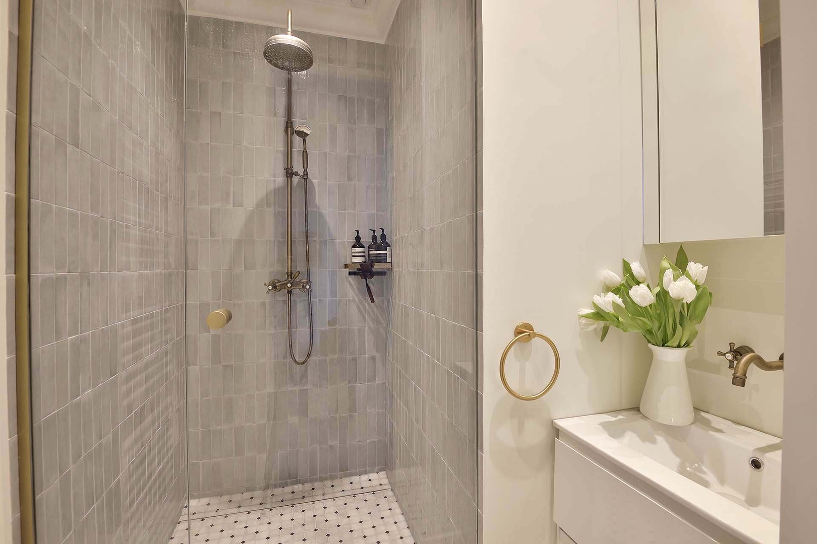 Bathroom 2 has a shower and sink. Toilet in separate powder room.