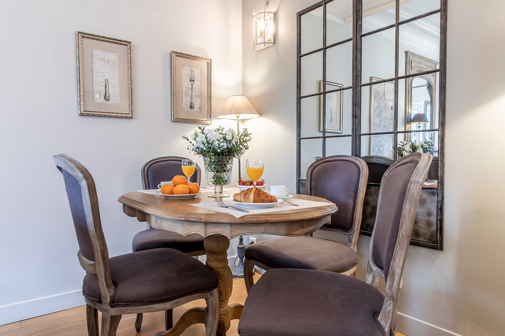 Enjoy French-style dinners at this elegant dining table for four.