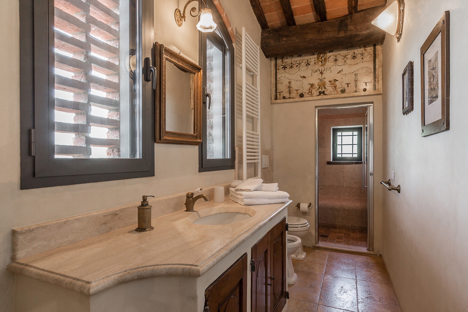 En suite bathroom to bedroom 1 has a large shower and good countertop space around the sink.