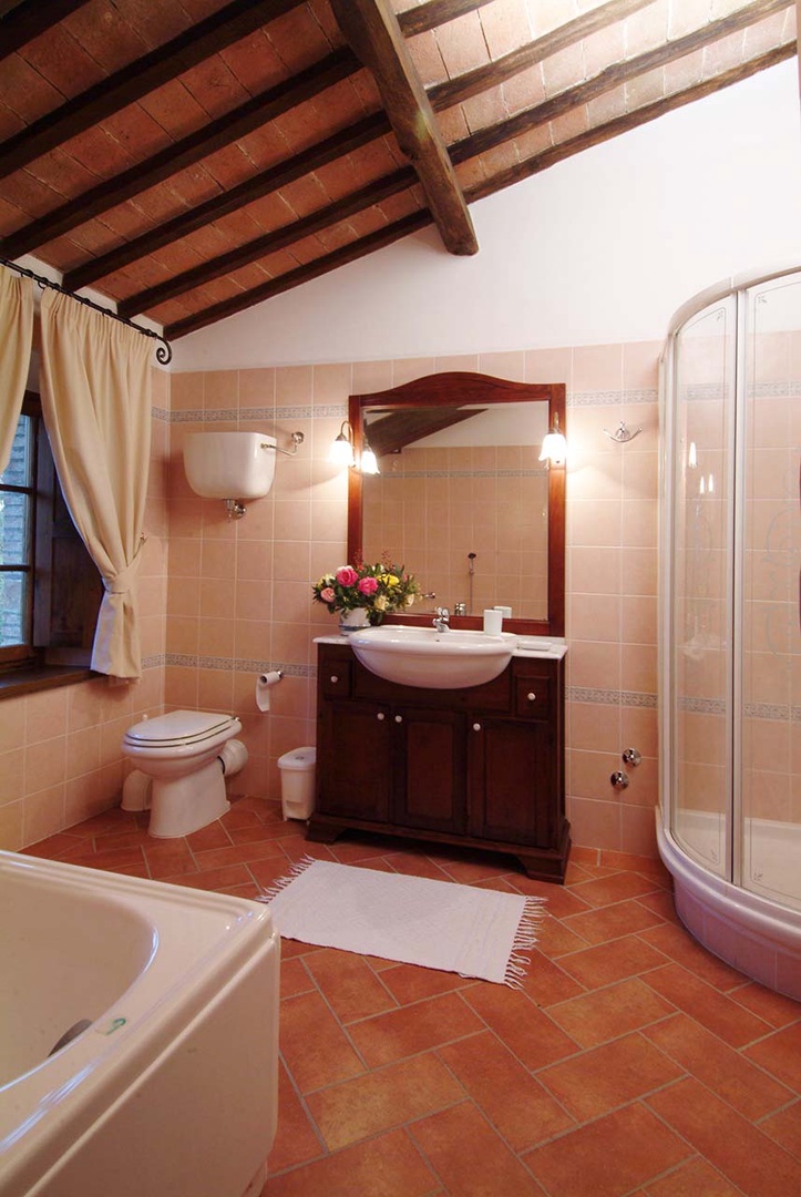 En suite bathroom with bathub and shower