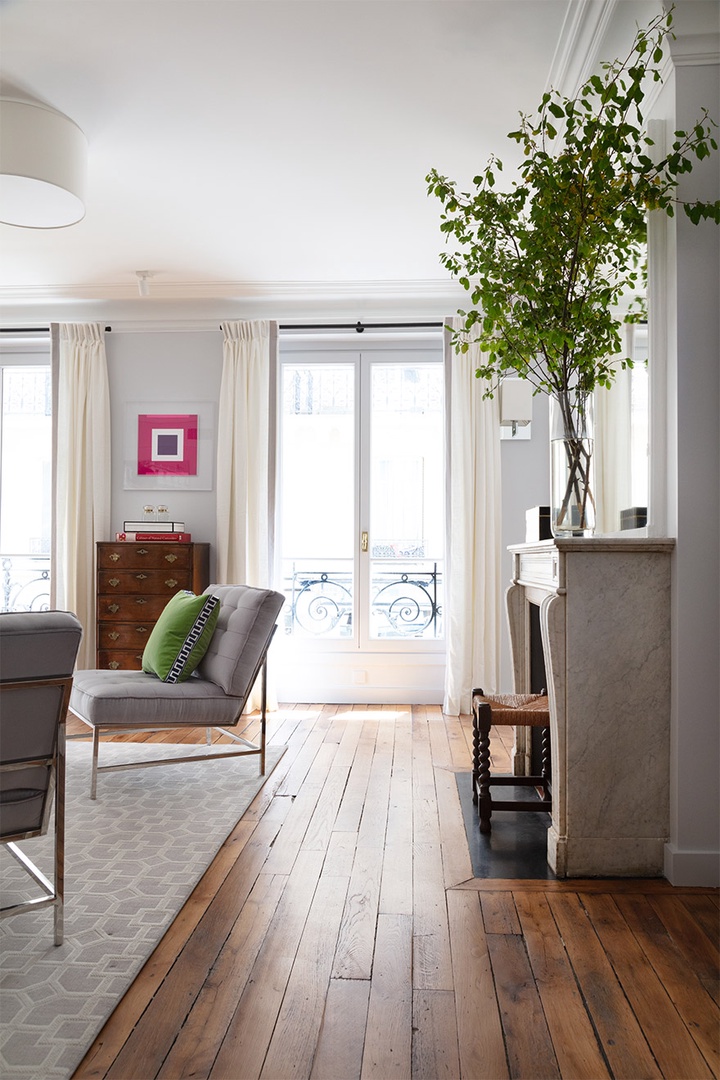 The marble fireplace is a centerpiece of the living room.