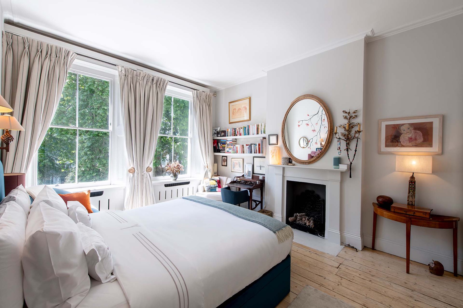 Beautiful English bedroom with antiques and desk.