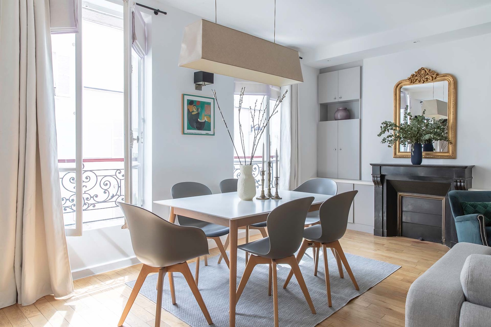 Sleek dinning area next to large French windows.