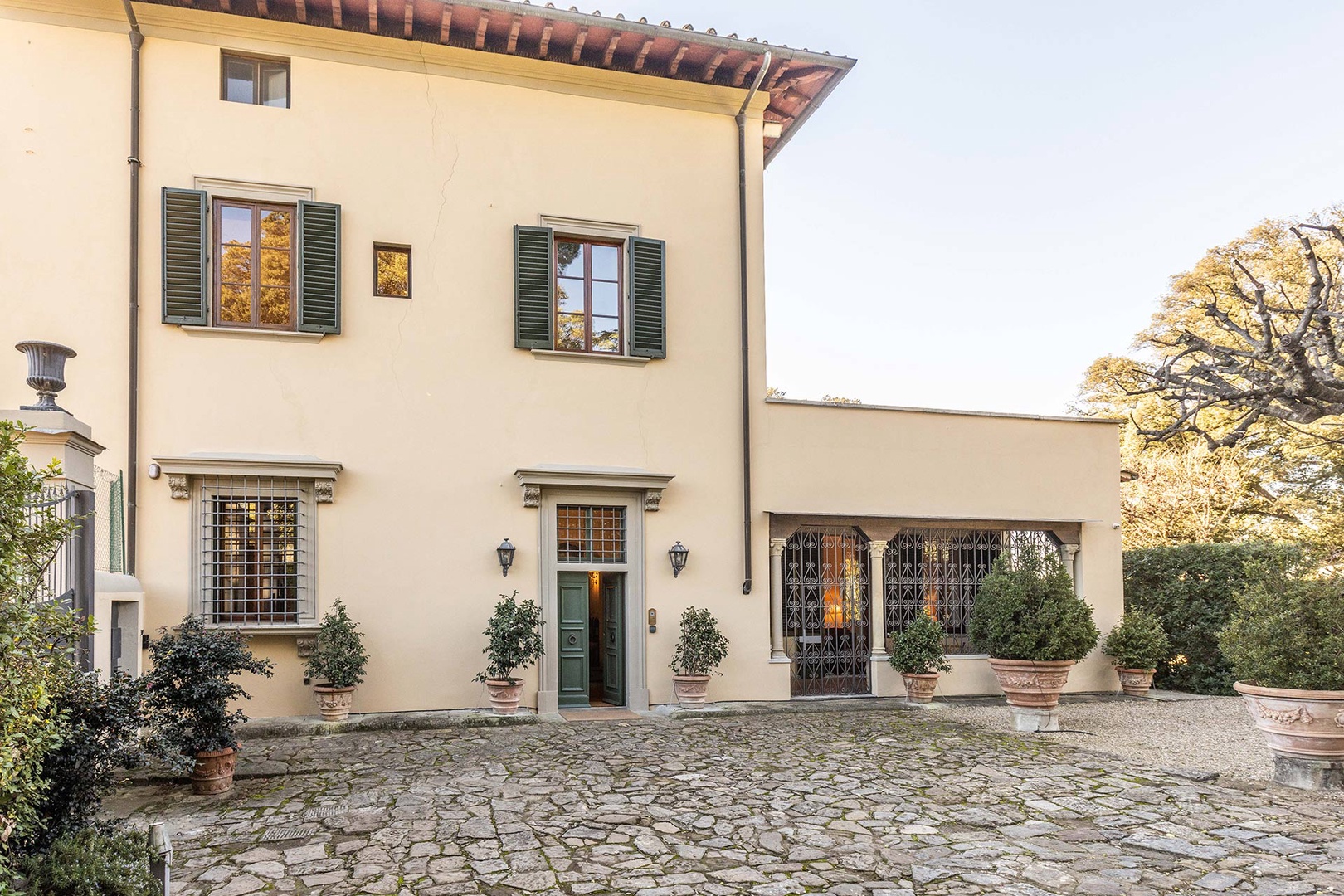 To the right of the  front door is to the Loggia above it is the upstairs terrace with hot tub.