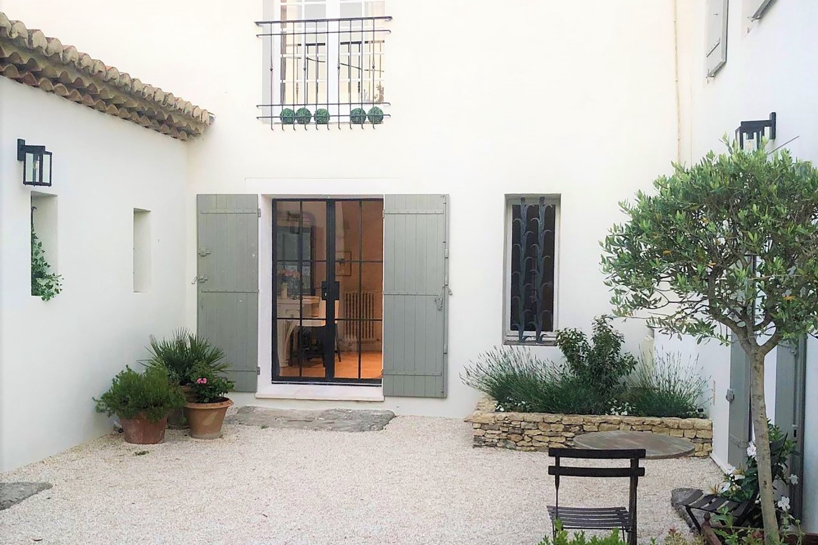 Courtyard entrance to kitchen (left) and Petite Maison (right)