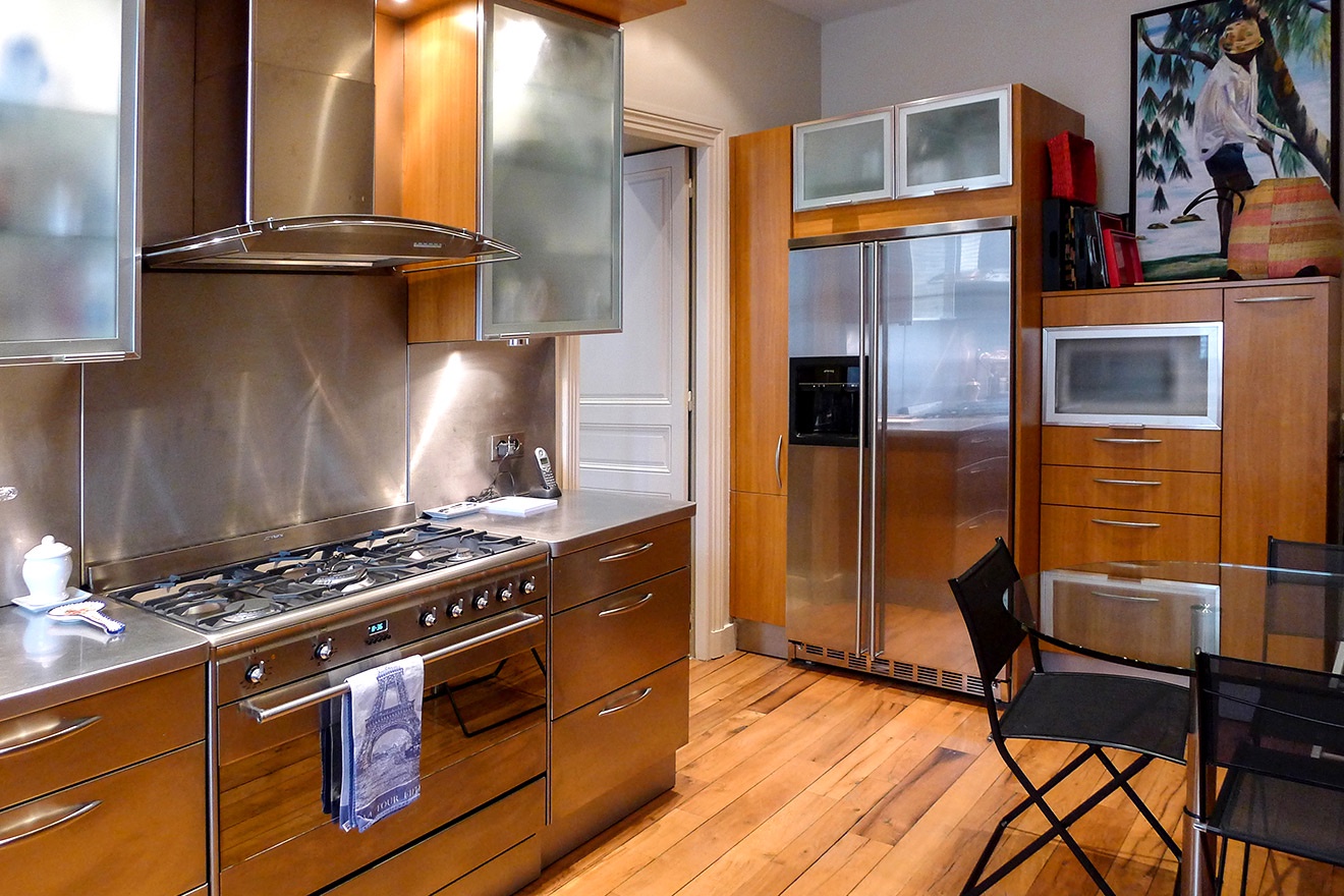 The functional kitchen features top-of-the-line appliances and easy access to the dining room.