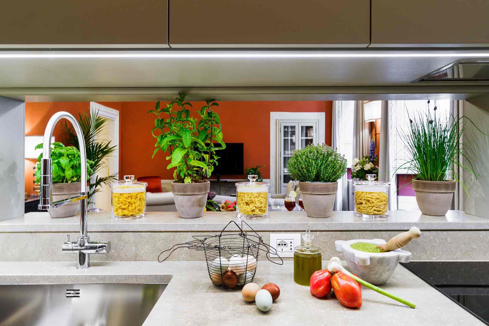 Step into the fully equipped kitchen where fresh herbs line the counter.