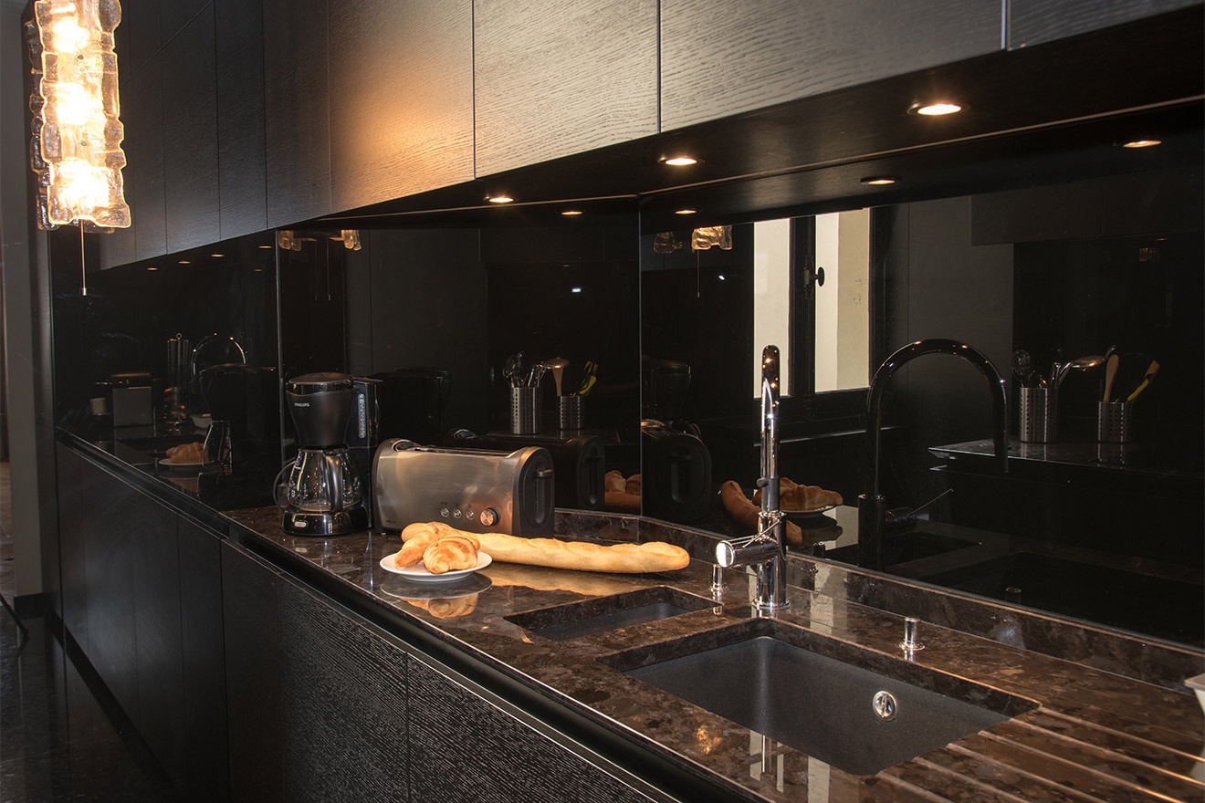 The sophisticated kitchen features high-quality modern appliances.