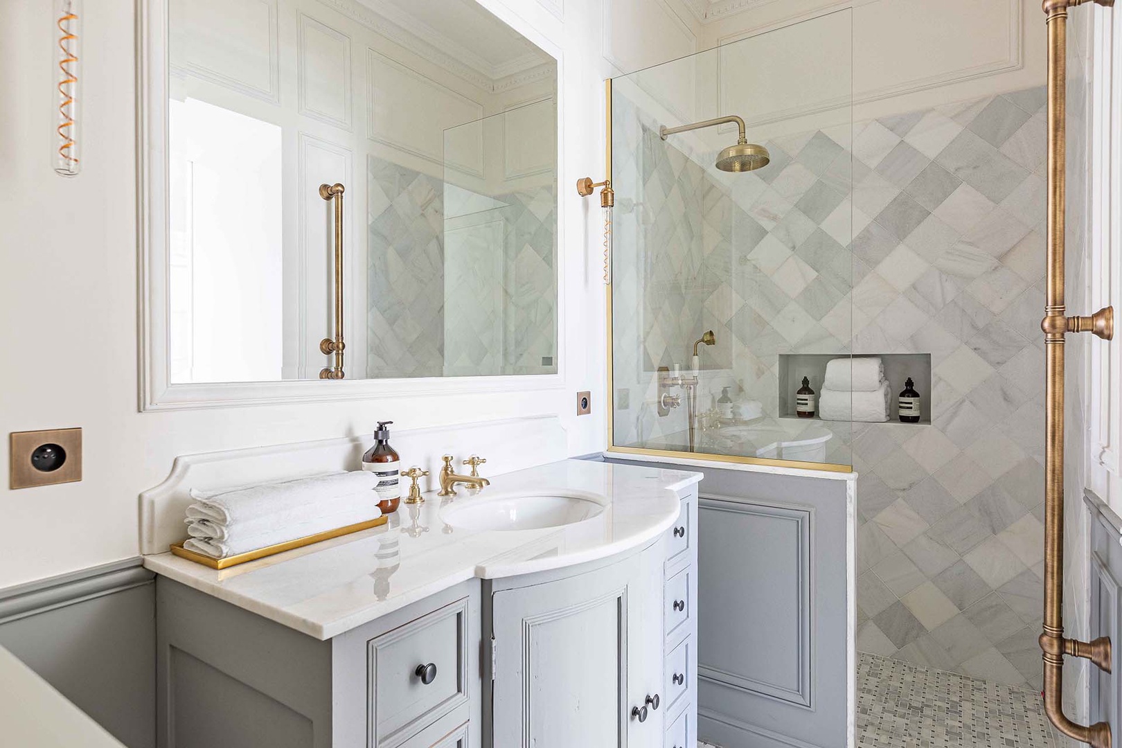 Large shower and gorgeous brass finishings in bathroom 2.