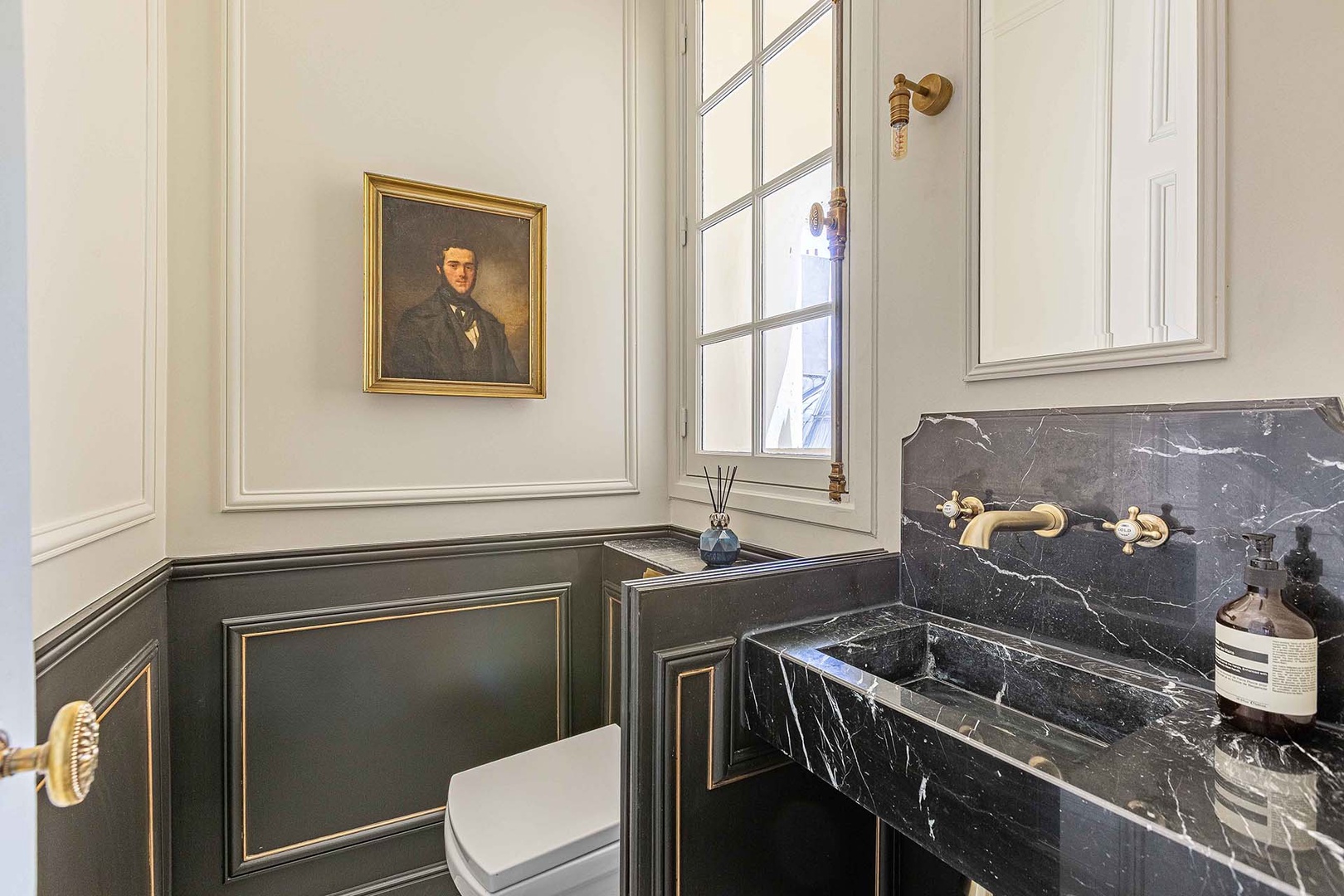 Powder room with toilet and sink near entrance.