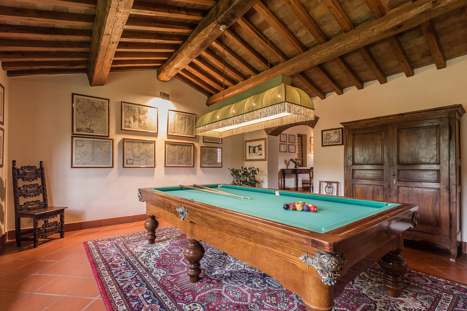 Enjoy a game of billiards! The bookcase has a small library that includes some books in English.