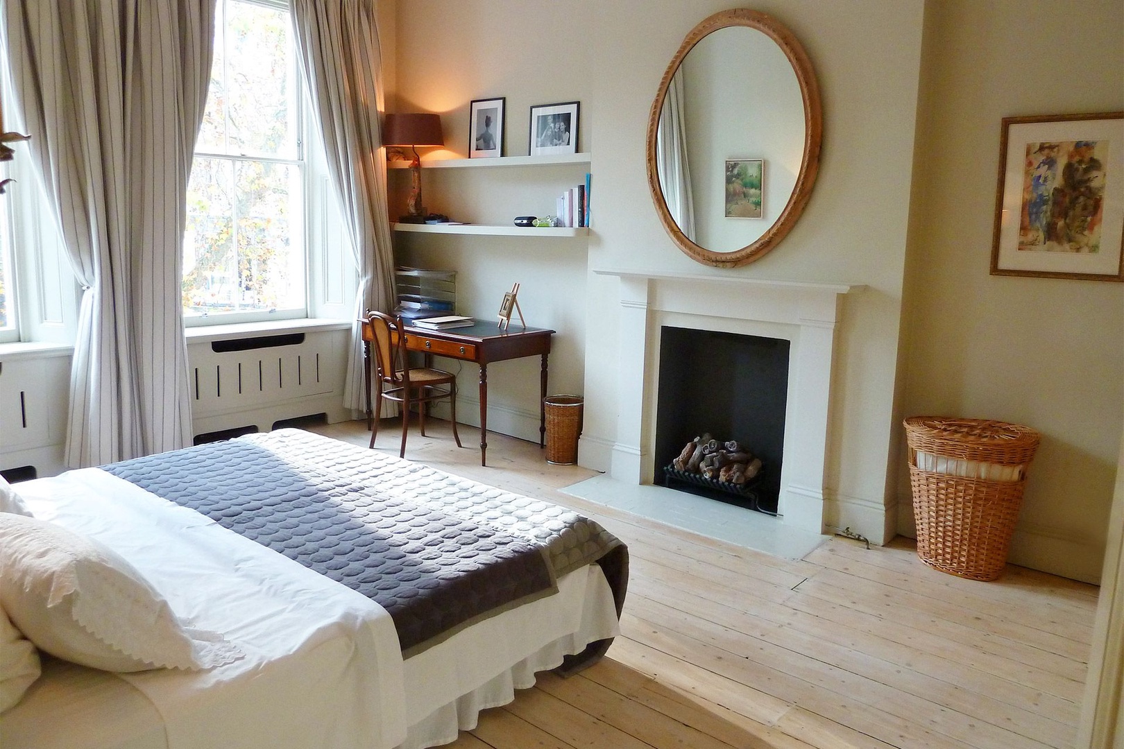 Beautiful English bedroom antiques, bleached oak floors and fireplace