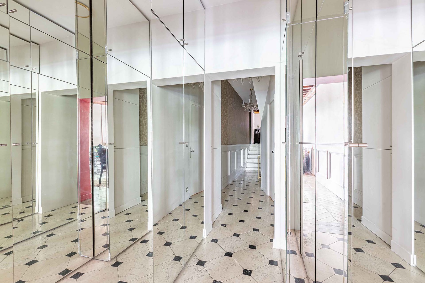 View of the hall with steps up to half bathroom.