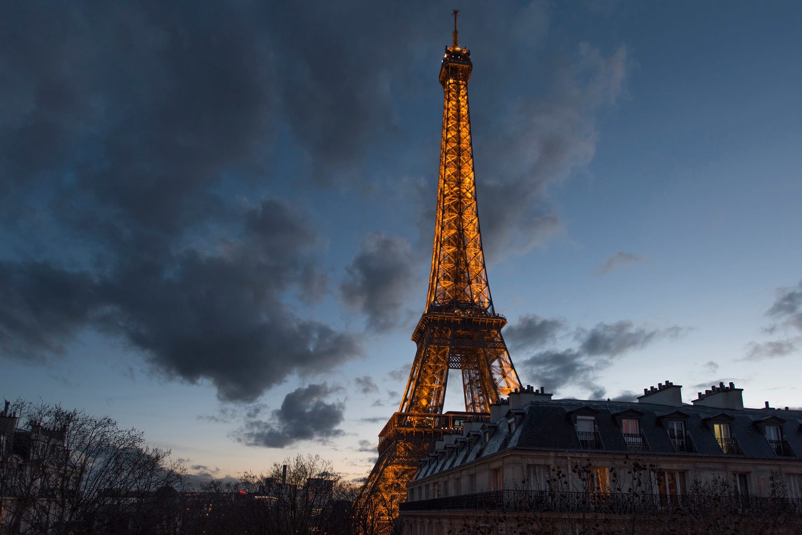 From the living room view the Eiffel Tower as it lights up the winter night sky.