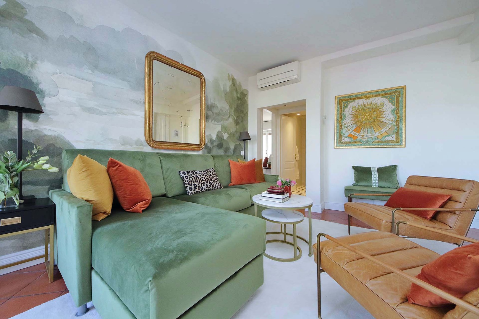 The elegant living room with artistic wallpaper and plush furnishings create your perfect retreat space.