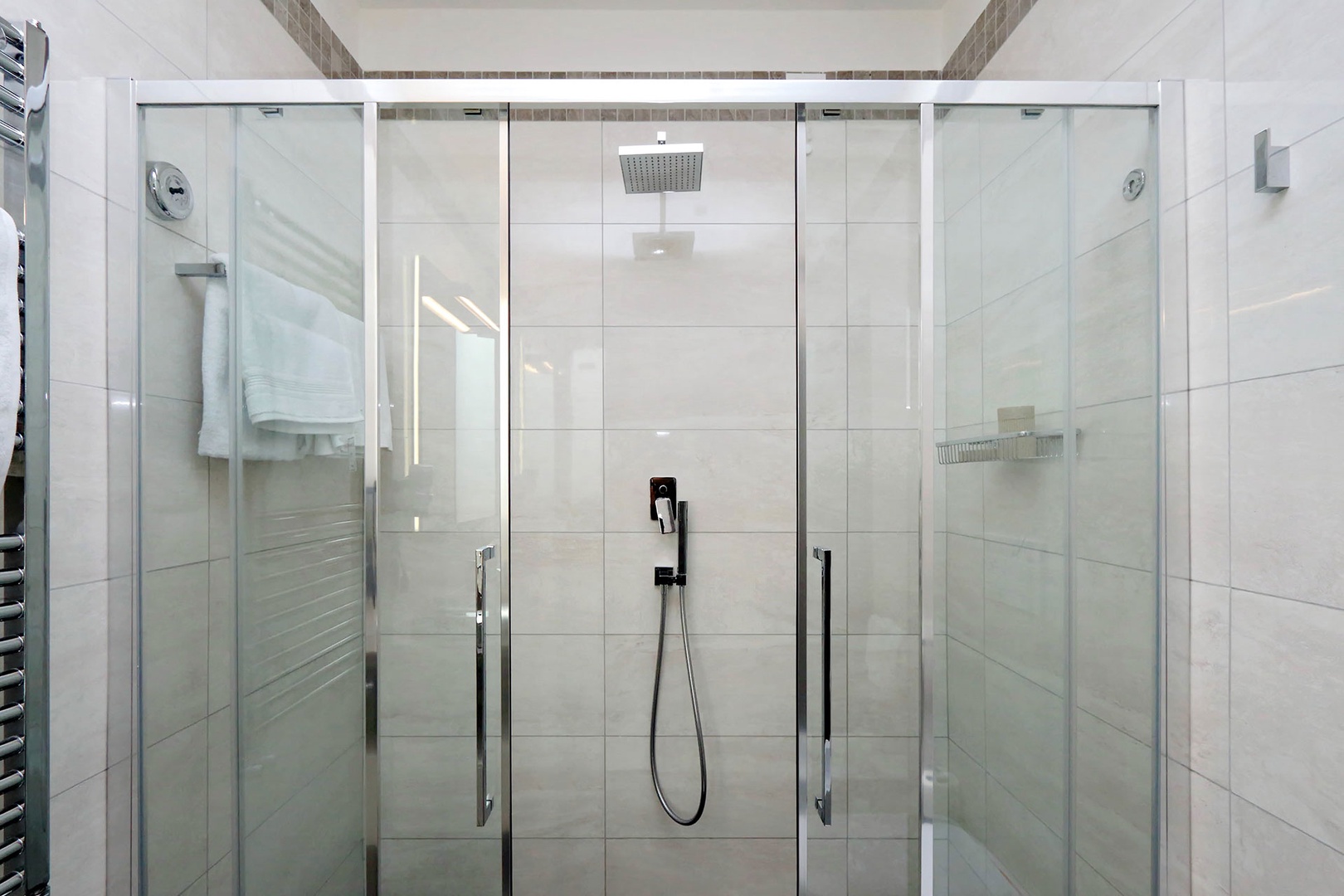 Very large glass enclosed shower.