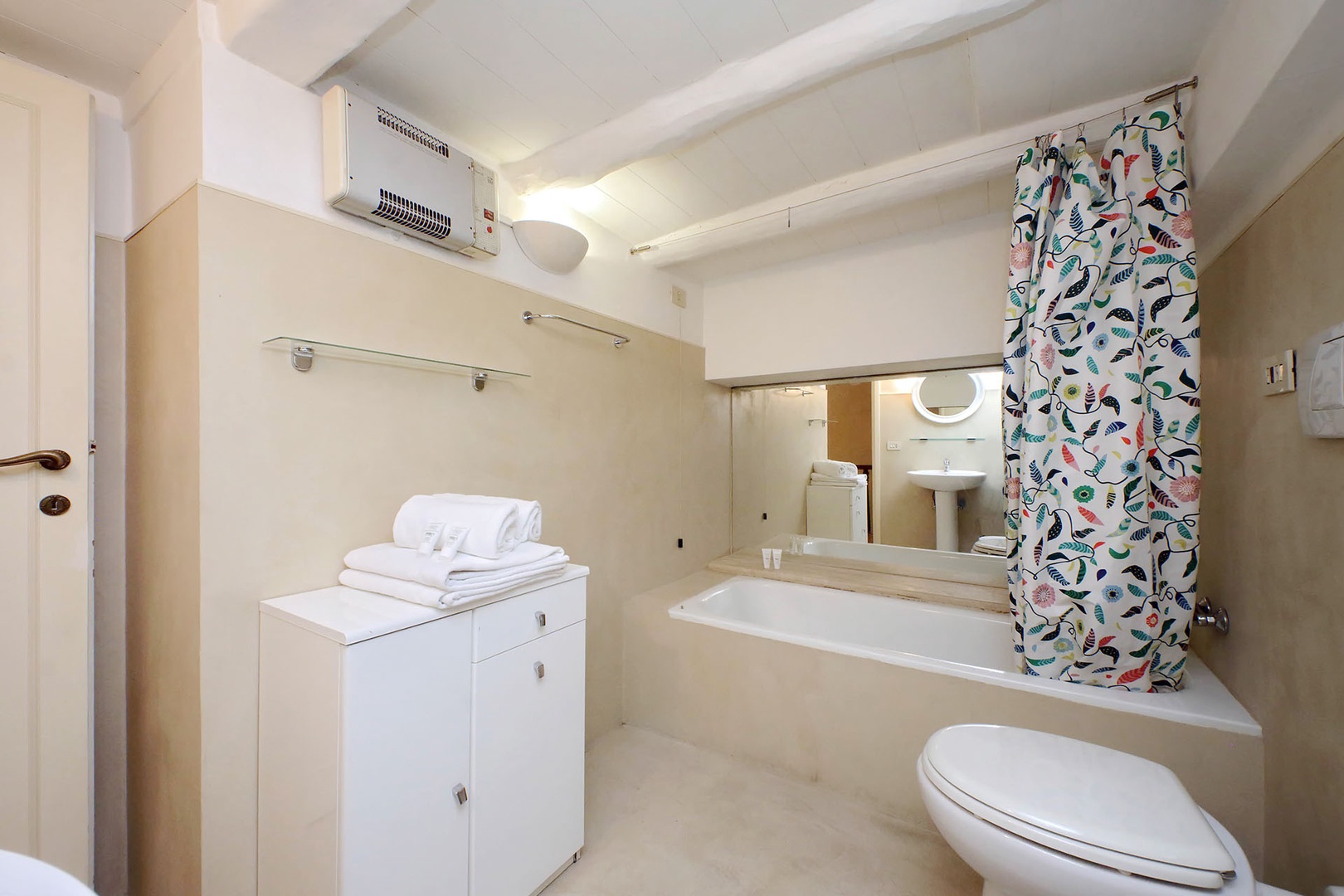 Bathroom has combo bathtub/shower, toilet and sink.