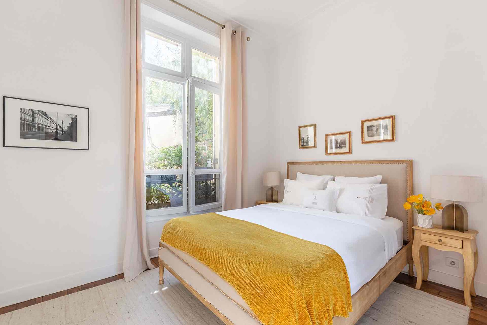 Large windows fill the bedroom with light.